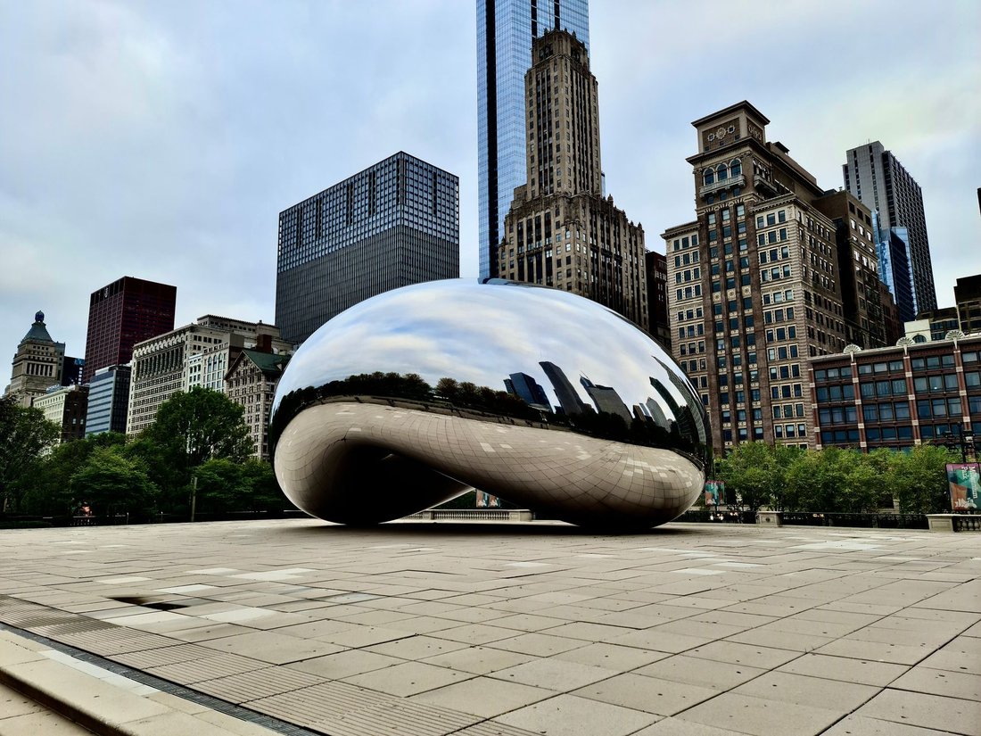 Cloud Gate sculpture reflecting the Chicago skyline in Millennium Park